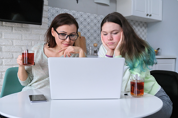 mother and daughter viewing virtual memorial on computer